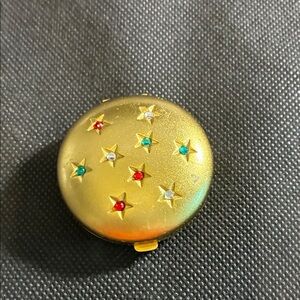 Avon rare Emeralds Goldtone with rhinestones cream to powder perfume compact.